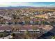 An aerial shot of a residential community surrounded by palm trees and scenic mountain vistas at 700 Aztec Cir # 12B, Mesquite, NV 89027