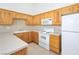 Efficient kitchen with wooden cabinets and white appliances at 700 Aztec Cir # 12B, Mesquite, NV 89027