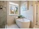 Bright bathroom featuring a large tub, shower, and window bringing in natural light at 7231 Adobe Hills Ave, Las Vegas, NV 89113