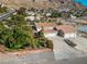 Expansive single-Gathering home featuring a three-car garage, circular driveway, and lush landscaping at 788 Rossmore Dr, Las Vegas, NV 89110