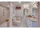 Bathroom featuring tiled walk-in shower, grab bars, and granite countertop at 788 Rossmore Dr, Las Vegas, NV 89110