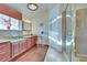 Bathroom features a vanity with lots of storage, a window, and glass enclosed shower at 788 Rossmore Dr, Las Vegas, NV 89110