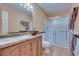 Well-lit bathroom featuring vanity with granite countertop and a glass-enclosed shower, providing a refreshing space at 788 Rossmore Dr, Las Vegas, NV 89110