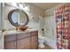 Bathroom with granite vanity, decorative sink, circular mirror, and a shower and tub combination at 788 Rossmore Dr, Las Vegas, NV 89110