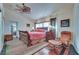 Comfortable bedroom features a ceiling fan, wood floors, and a comfortable reading chair at 788 Rossmore Dr, Las Vegas, NV 89110