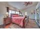 Bedroom features a ceiling fan, wood floors, and a large bed at 788 Rossmore Dr, Las Vegas, NV 89110