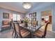 Charming dining room with vaulted ceilings, a modern chandelier, and views of the kitchen at 788 Rossmore Dr, Las Vegas, NV 89110