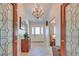 Elegant foyer features decorative glass doors, chandelier lighting, and a classic tile floor at 788 Rossmore Dr, Las Vegas, NV 89110