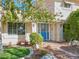 Charming home entrance with manicured landscaping, a decorative blue door, and a welcoming pathway at 788 Rossmore Dr, Las Vegas, NV 89110