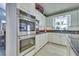 Modern kitchen featuring stainless steel appliances, granite countertops, and white cabinets at 788 Rossmore Dr, Las Vegas, NV 89110