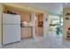 Bright kitchen with neutral cabinets, white appliances, and tiled floor at 788 Rossmore Dr, Las Vegas, NV 89110