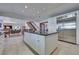 Bright kitchen with a stainless steel refrigerator, white cabinets, and a granite island at 788 Rossmore Dr, Las Vegas, NV 89110
