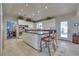Open kitchen with a granite island, white cabinets, and views into the dining and living spaces at 788 Rossmore Dr, Las Vegas, NV 89110