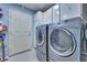 Laundry room with washer, dryer, storage cabinets, and utility door at 788 Rossmore Dr, Las Vegas, NV 89110