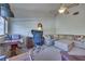 Inviting living room with comfortable seating, a workspace, and a ceiling fan, creating a relaxing atmosphere at 788 Rossmore Dr, Las Vegas, NV 89110
