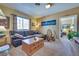 Comfortable living room with leather sofa and lots of light from big window at 788 Rossmore Dr, Las Vegas, NV 89110