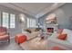 Inviting living room showcasing a fireplace, white sofas, wood floors, and bright lighting at 788 Rossmore Dr, Las Vegas, NV 89110