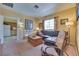 Comfortable living room with leather sofa and lots of light from big window at 788 Rossmore Dr, Las Vegas, NV 89110