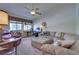 Spacious living room featuring comfortable seating, a desk, and a large window, perfect for relaxation at 788 Rossmore Dr, Las Vegas, NV 89110