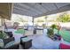 View of the outdoor kitchen area under the patio covering with grill and bar seating at 788 Rossmore Dr, Las Vegas, NV 89110