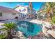 Backyard pool surrounded by rocks and palm trees providing a relaxing oasis for outdoor enjoyment at 788 Rossmore Dr, Las Vegas, NV 89110