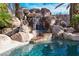 The backyard has a custom waterfall with a lagoon-style pool at 788 Rossmore Dr, Las Vegas, NV 89110