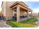 Covered back patio with desert landscaping, a grill, and mountain views in the distance at 7884 Patagonia Point Ct, Las Vegas, NV 89179