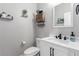 Bathroom featuring a vanity, framed mirror, decorative shelves and modern finishes at 7884 Patagonia Point Ct, Las Vegas, NV 89179