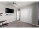 Spacious bedroom featuring a TV, storage closet, and an exercise bike for convenience and recreation at 7884 Patagonia Point Ct, Las Vegas, NV 89179