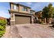 Two-story home with a two car garage and brick-paved driveway at 7884 Patagonia Point Ct, Las Vegas, NV 89179