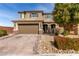 Two-story home with a two car garage and desert landscaping at 7884 Patagonia Point Ct, Las Vegas, NV 89179