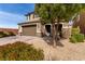 Two-story home with a two car garage and desert landscaping at 7884 Patagonia Point Ct, Las Vegas, NV 89179