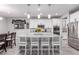 Modern kitchen with an island, stainless steel appliances, and stylish white cabinetry at 7884 Patagonia Point Ct, Las Vegas, NV 89179