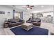 Inviting living room with cozy leather sofas, ceiling fan, and stylish decor at 7884 Patagonia Point Ct, Las Vegas, NV 89179