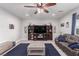 Spacious living room with a mounted TV, shelving, and stylish decor at 7884 Patagonia Point Ct, Las Vegas, NV 89179
