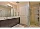 Well-lit bathroom with a double sink vanity and a glass-enclosed shower at 8255 Las Vegas Blvd # 313, Las Vegas, NV 89123