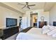 Bright bedroom featuring a ceiling fan, TV, and ensuite bathroom at 8255 Las Vegas Blvd # 313, Las Vegas, NV 89123