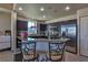 Contemporary kitchen with stainless steel appliances, dark cabinetry, and a granite countertop at 8255 Las Vegas Blvd # 313, Las Vegas, NV 89123