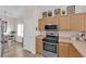 Well-lit kitchen with stainless steel appliances and light wood cabinets at 9339 Square Dance Pl # 103, Las Vegas, NV 89178