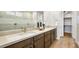 Bathroom featuring a double vanity with wooden cabinets, mirrors and a walk-in closet at 97 Tardando Ave, Henderson, NV 89015