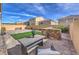 Backyard boasts a stone patio, BBQ, seating, and artificial turf at 9876 Parador Cellars Ct, Las Vegas, NV 89141