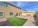 Artificial grass backyard with a stone-paver patio, seating, and BBQ grill at 9876 Parador Cellars Ct, Las Vegas, NV 89141
