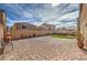 Spacious backyard with stone patio, artificial turf, BBQ, and seating at 9876 Parador Cellars Ct, Las Vegas, NV 89141