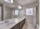 Bathroom with a double sink vanity, large mirror, and shower with tub at 9876 Parador Cellars Ct, Las Vegas, NV 89141