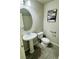 Powder room with pedestal sink, oval mirror, artwork, and brushed metal assist bars at 9876 Parador Cellars Ct, Las Vegas, NV 89141