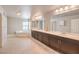Bathroom features wood-look tile flooring, double sinks, and a large bathtub at 9876 Parador Cellars Ct, Las Vegas, NV 89141