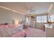 Charming bedroom with bright pink accents and lots of natural light at 9876 Parador Cellars Ct, Las Vegas, NV 89141
