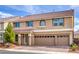 Charming two-story home with a three-car garage and lush landscaping creating an inviting exterior at 9876 Parador Cellars Ct, Las Vegas, NV 89141