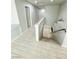 Bright hallway with wood flooring, painted walls, and a view of stairs at 9876 Parador Cellars Ct, Las Vegas, NV 89141
