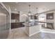 Modern kitchen featuring dark cabinets, mosaic backsplash, and a large island with granite countertop at 9876 Parador Cellars Ct, Las Vegas, NV 89141